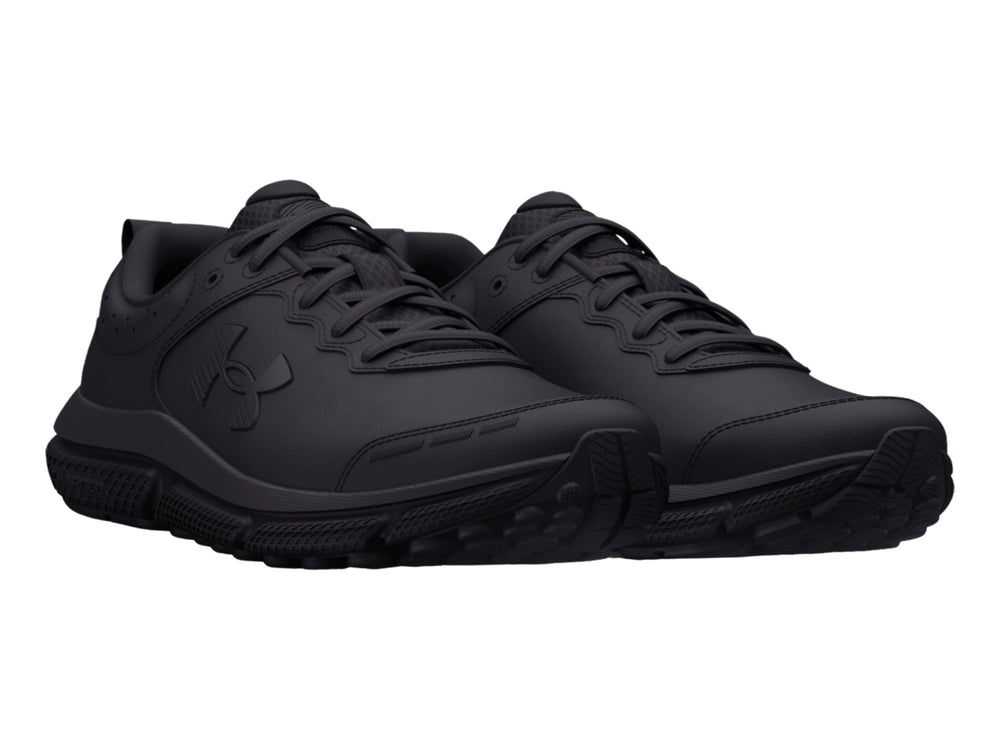 Tenis deportivos Under Armour color negro total para niños, vista lateral.
