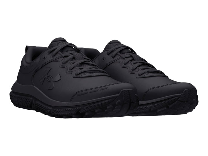 Tenis deportivos Under Armour color negro total para niños, vista lateral.