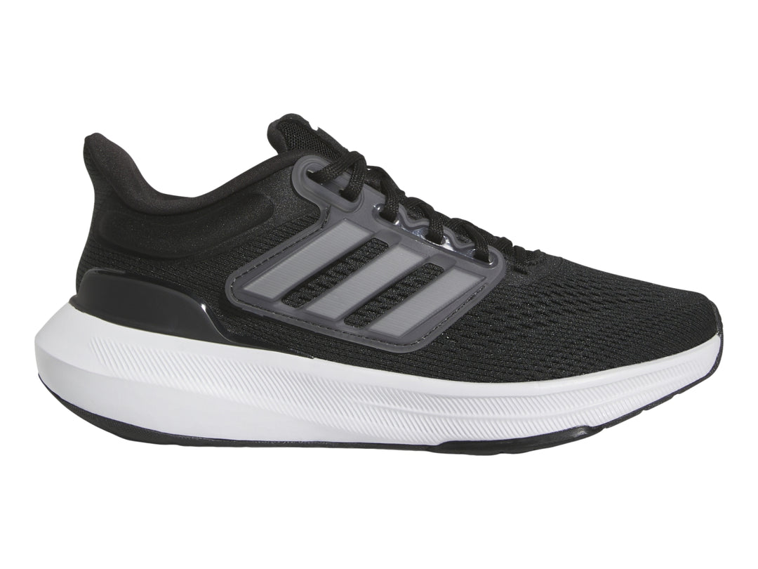 Tenis deportivos Adidas Ultrabounce en color negro con suela blanca y detalles grises para niño.
