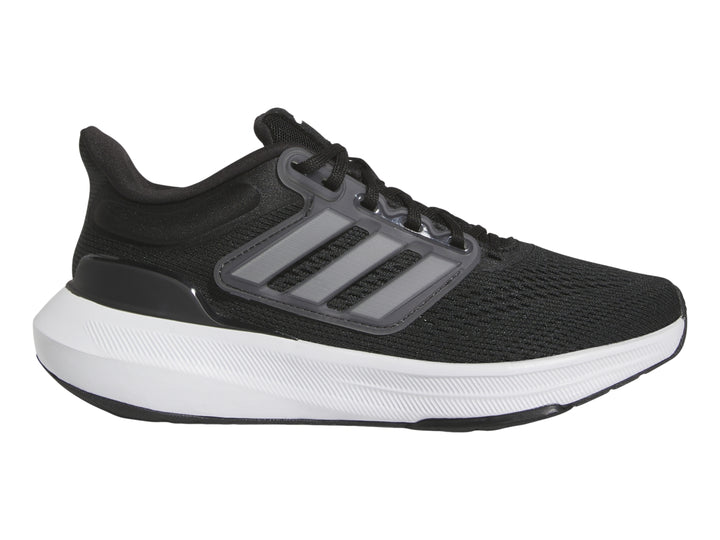 Tenis deportivos Adidas Ultrabounce en color negro con suela blanca y detalles grises para niño.