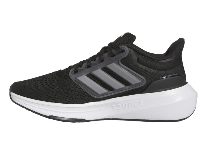 Tenis deportivos Adidas Ultrabounce en color negro con suela blanca y detalles grises para niño.