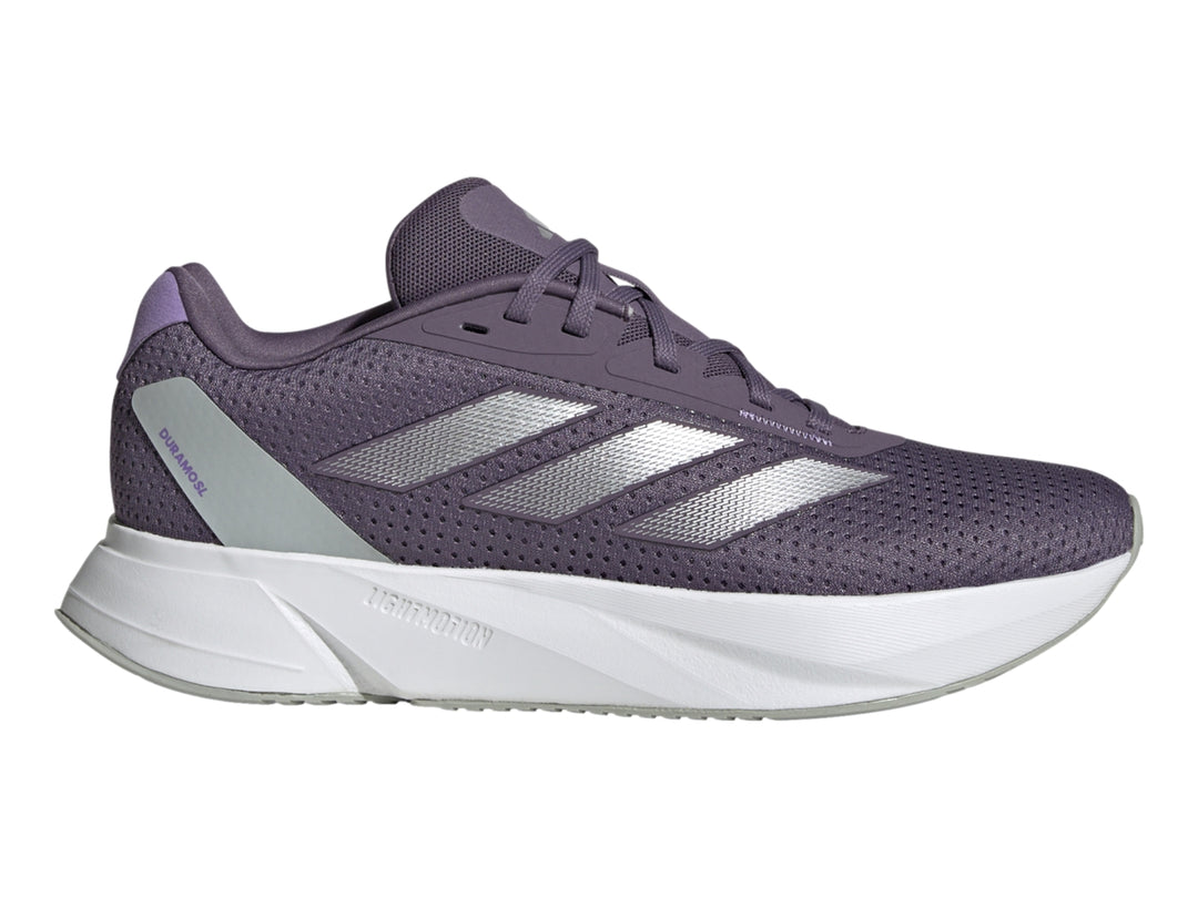 Tenis deportivos Adidas color morado con franjas plateadas y suela blanca.