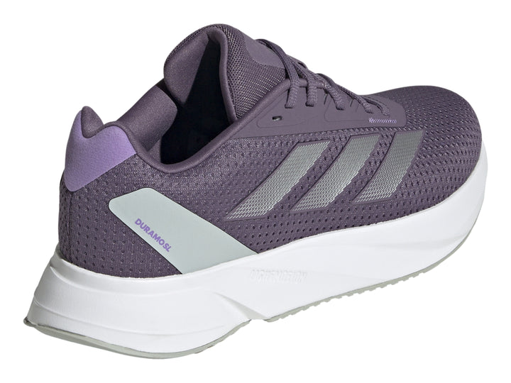 Tenis deportivos Adidas color morado con franjas plateadas y suela blanca.
