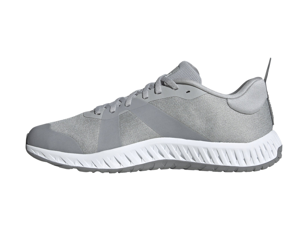 Tenis deportivos Adidas en color gris con franjas blancas y suela blanca Dual Density.