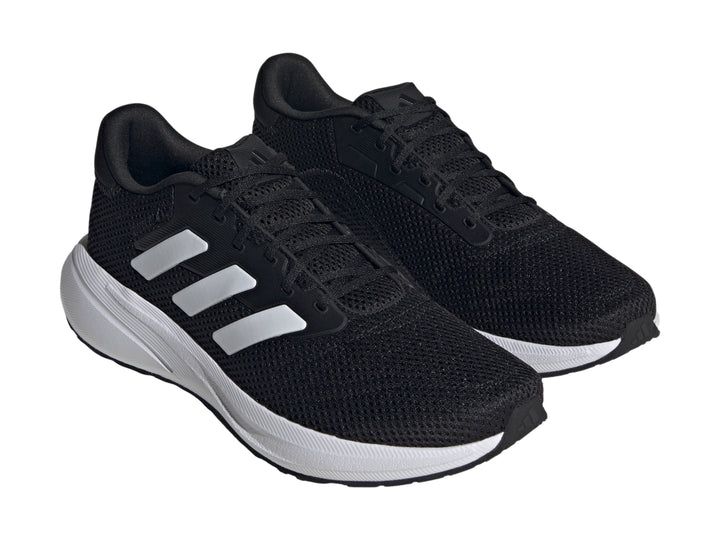 Tenis deportivos Adidas Response Runner color negro con suela y franjas laterales blancas.
