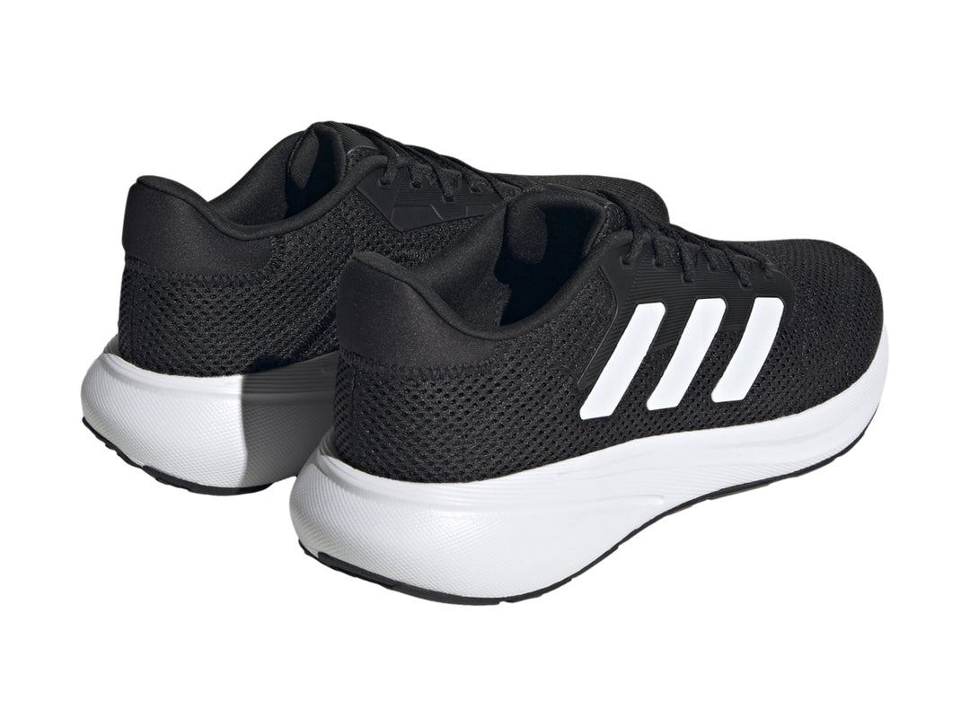 Tenis deportivos Adidas Response Runner color negro con suela y franjas laterales blancas.