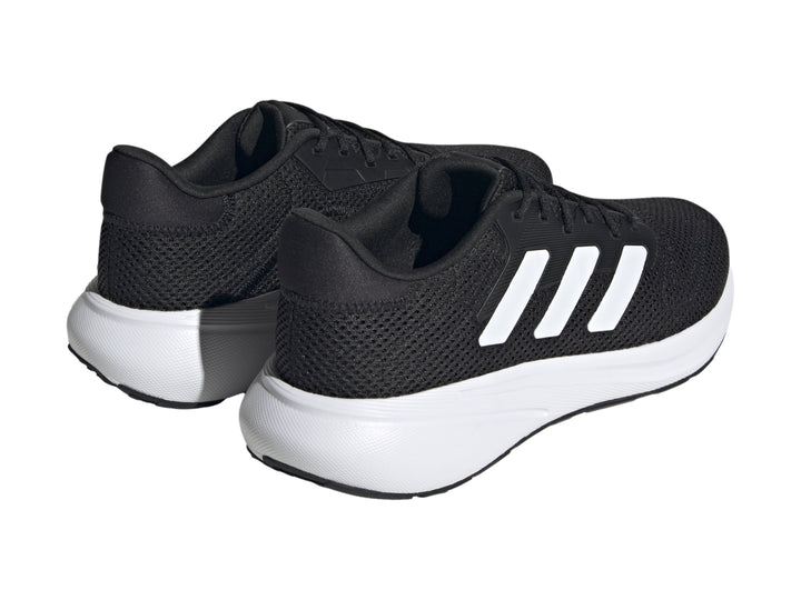 Tenis deportivos Adidas Response Runner color negro con suela y franjas laterales blancas.