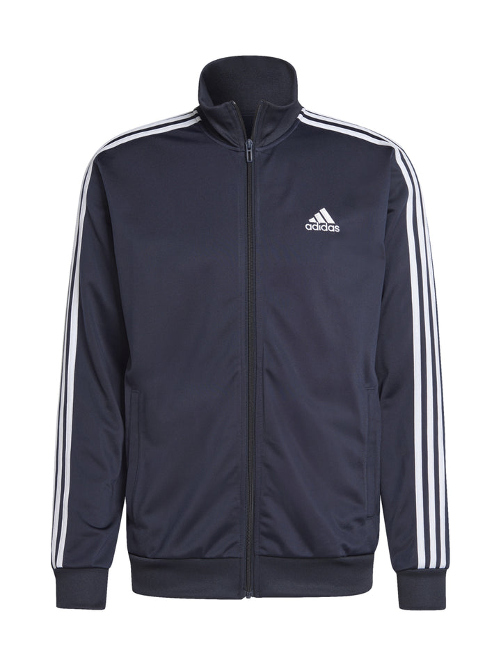 Conjunto deportivo Adidas azul marino con rayas blancas laterales en chaqueta y pantalón.