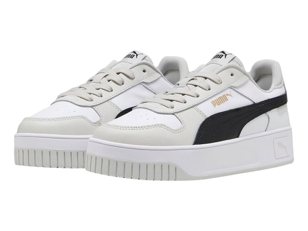 Tenis PUMA Carina Street blancos con franja negra y detalles en gris, con suela de plataforma.