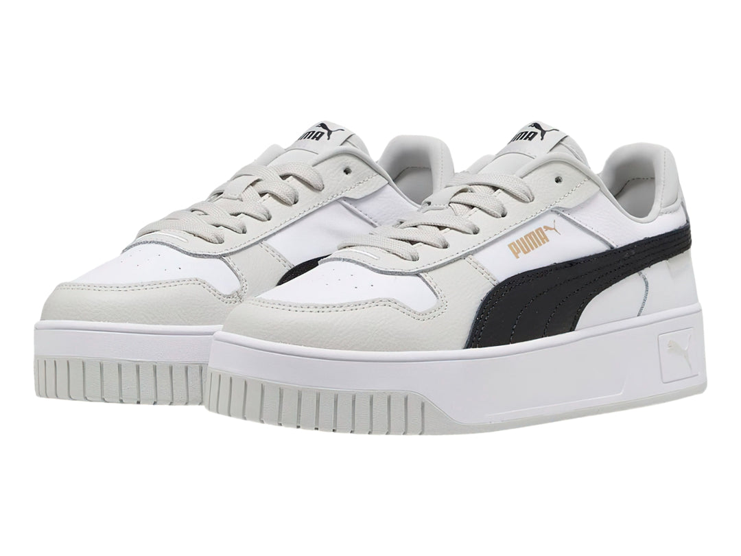 Tenis PUMA Carina Street blancos con franja negra y detalles en gris, con suela de plataforma.
