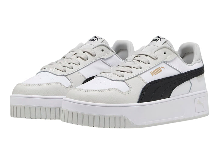Tenis PUMA Carina Street blancos con franja negra y detalles en gris, con suela de plataforma.
