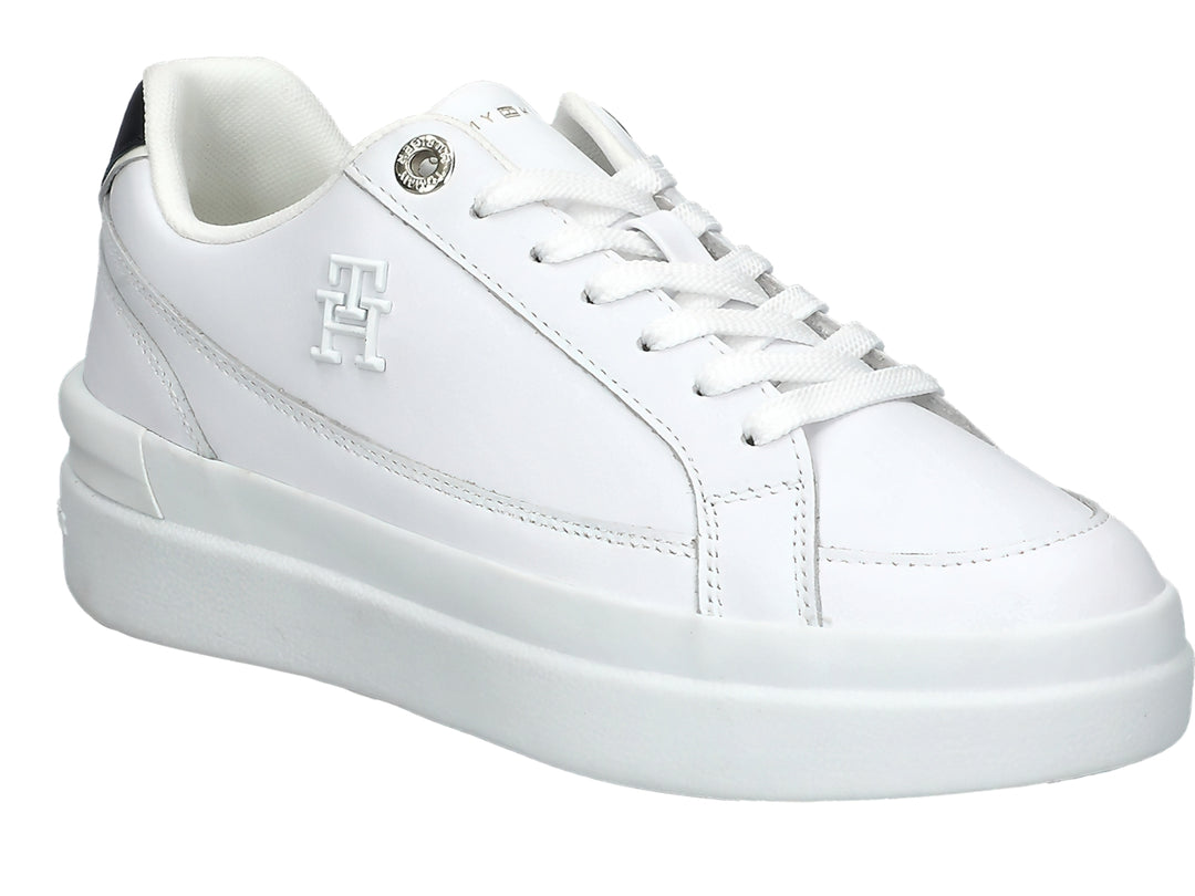 Tenis Tommy Hilfiger color blanco con suela elevada y detalle negro en el talón.