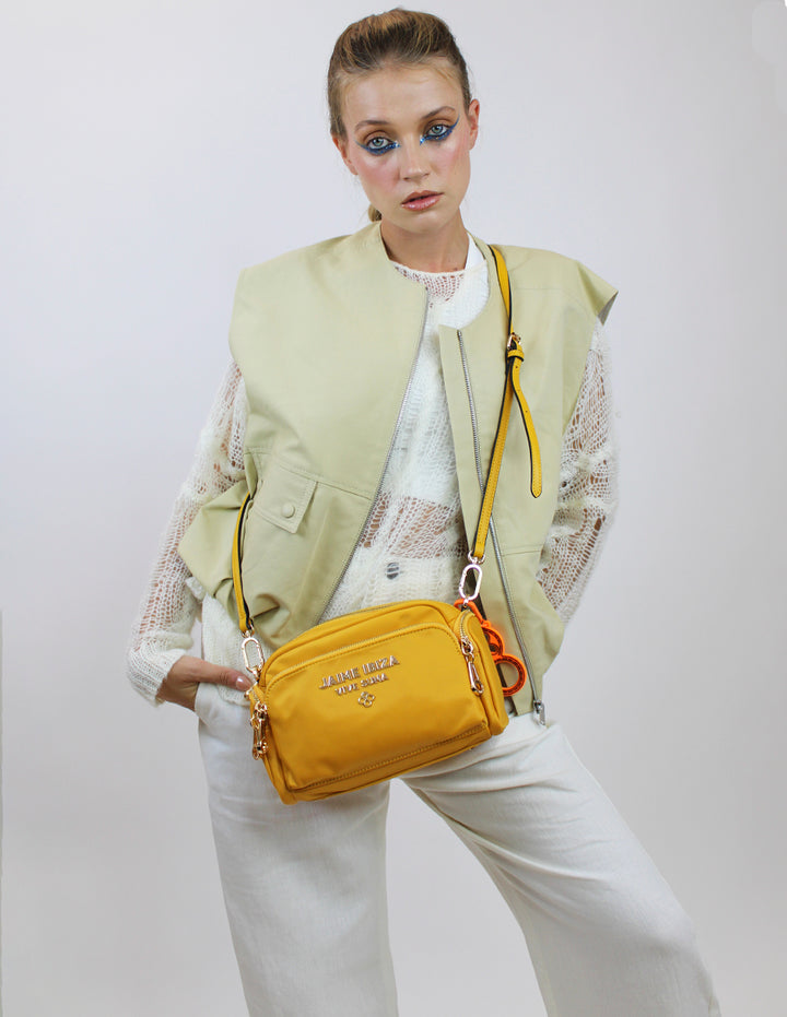 Bolso pequeño color mostaza de la marca Jaime Ibiza con correa ancha y detalles metálicos dorados.