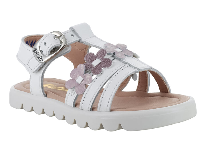 Sandalia blanca para niña con flores rosas brillantes y suela blanca ondulada.