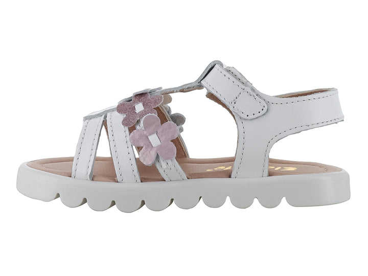 Sandalia blanca para niña con flores rosas brillantes y suela blanca ondulada.