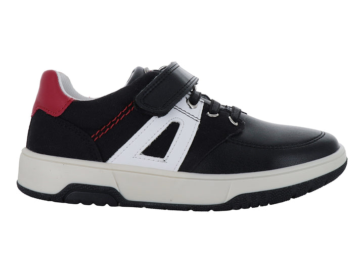 Zapato infantil negro con detalles blancos y rojos, suela blanca y cierre de velcro.