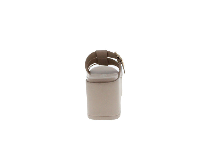 Sandalia de plataforma color beige con hebilla dorada y suela gruesa.