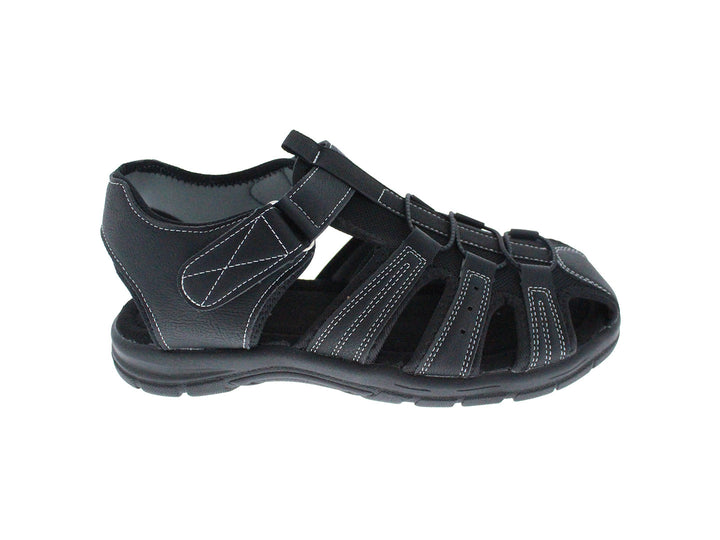 Sandalia cerrada color negro para niño con costuras blancas y cierre de velcro.