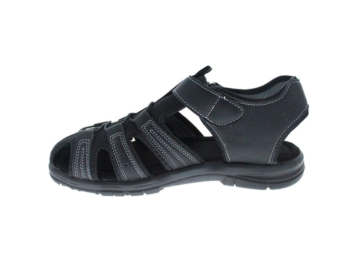 Sandalia cerrada color negro para niño con costuras blancas y cierre de velcro.