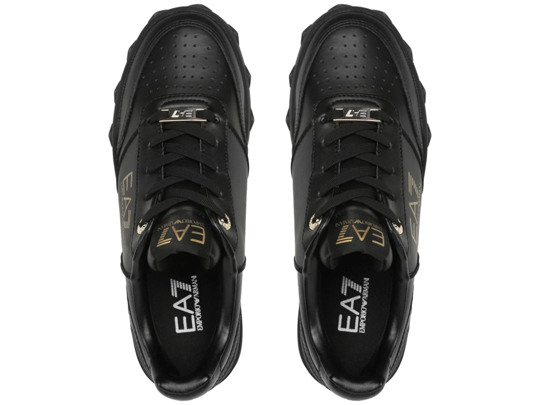Tenis negros Emporio Armani con logotipo dorado EA7 y estrellas grabadas en la suela.