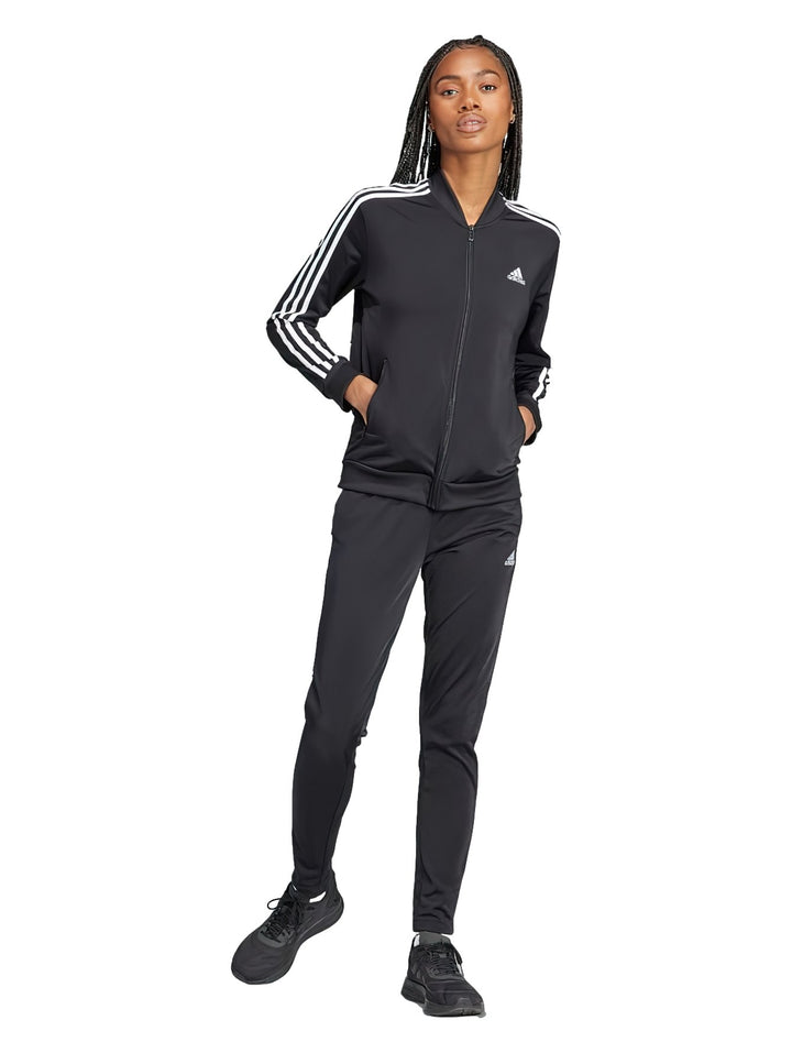 Conjunto deportivo Adidas negro con tres rayas blancas laterales, compuesto por chaqueta y pantalón.