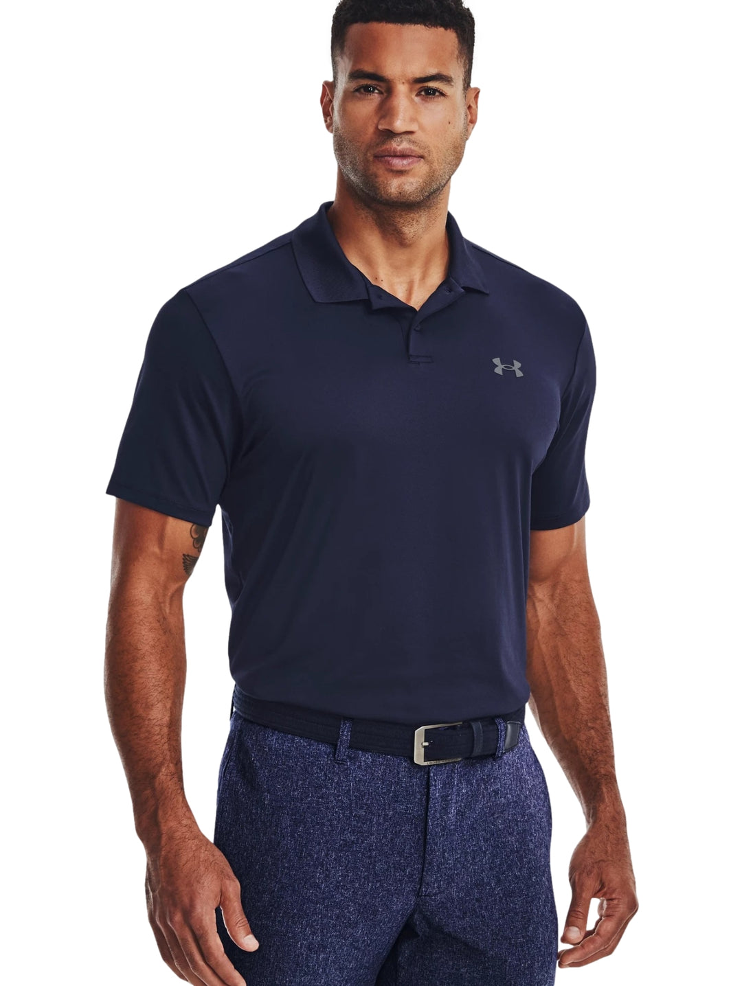 Hombre vistiendo una playera polo Under Armour de color azul marino con logotipo en el pecho.
