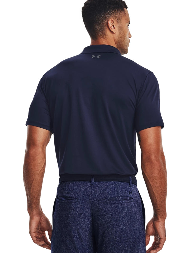 Hombre vistiendo una playera polo Under Armour de color azul marino con logotipo en el pecho.