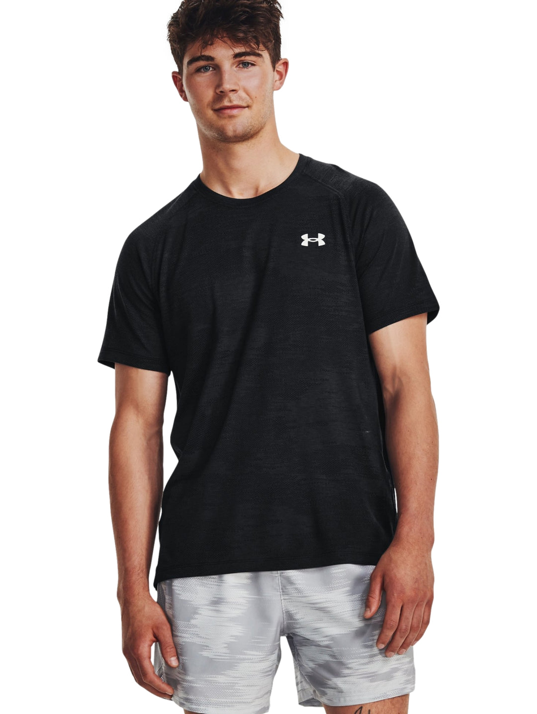 Hombre vistiendo una camiseta deportiva de manga corta color negro de la marca Under Armour.