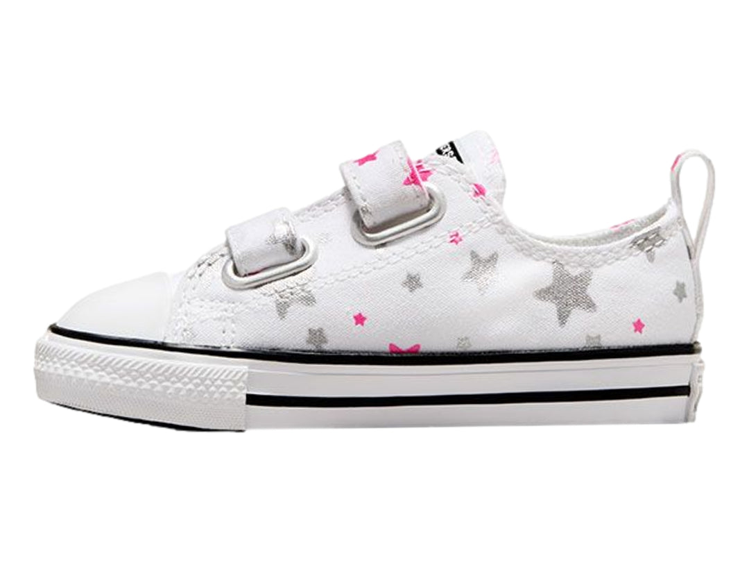 Tenis Converse blancos para niño o niña con estampado de estrellas grises y rosas, cierre de velcro y suela blanca.