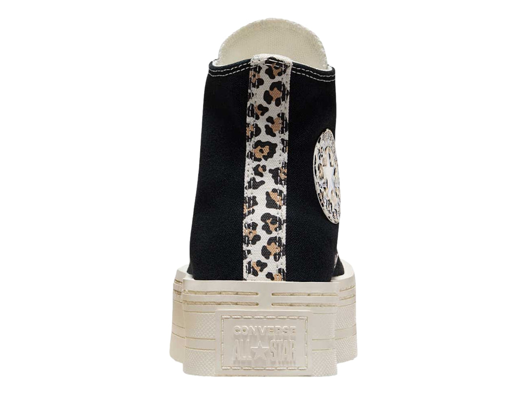 Tenis Converse negros de bota con suela de plataforma blanca y detalles en estampado de leopardo.