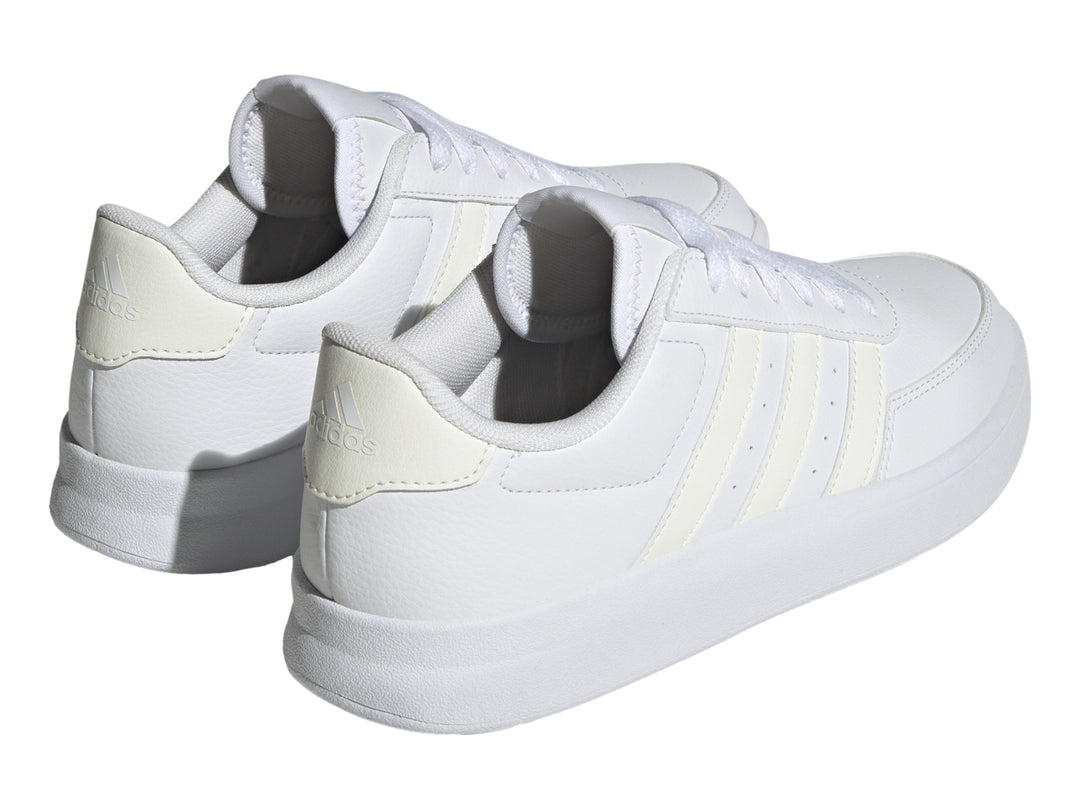 Tenis Adidas Breaknet 2.0 en color blanco con tres franjas laterales en tono crema y suela blanca.