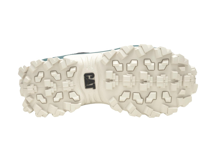Tenis Caterpillar negros con suela gruesa color crema y detalles en verde oscuro.