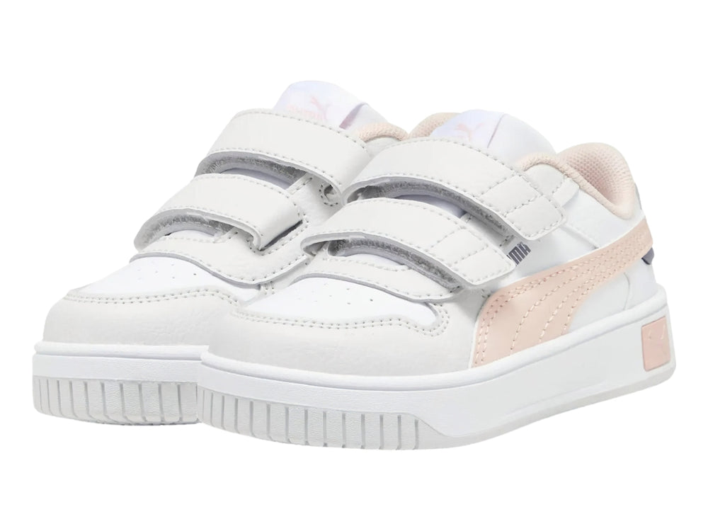 Tenis PUMA blancos para niña con franja rosa y cierre de velcro.