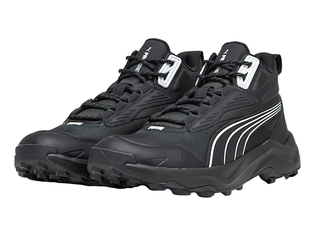 Tenis deportivos PUMA de corte medio en color negro con detalles en blanco y suela robusta.
