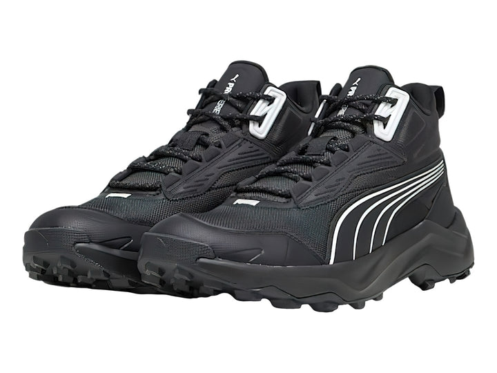 Tenis deportivos PUMA de corte medio en color negro con detalles en blanco y suela robusta.