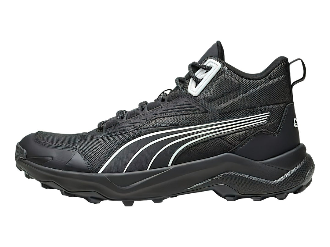 Tenis deportivos PUMA de corte medio en color negro con detalles en blanco y suela robusta.