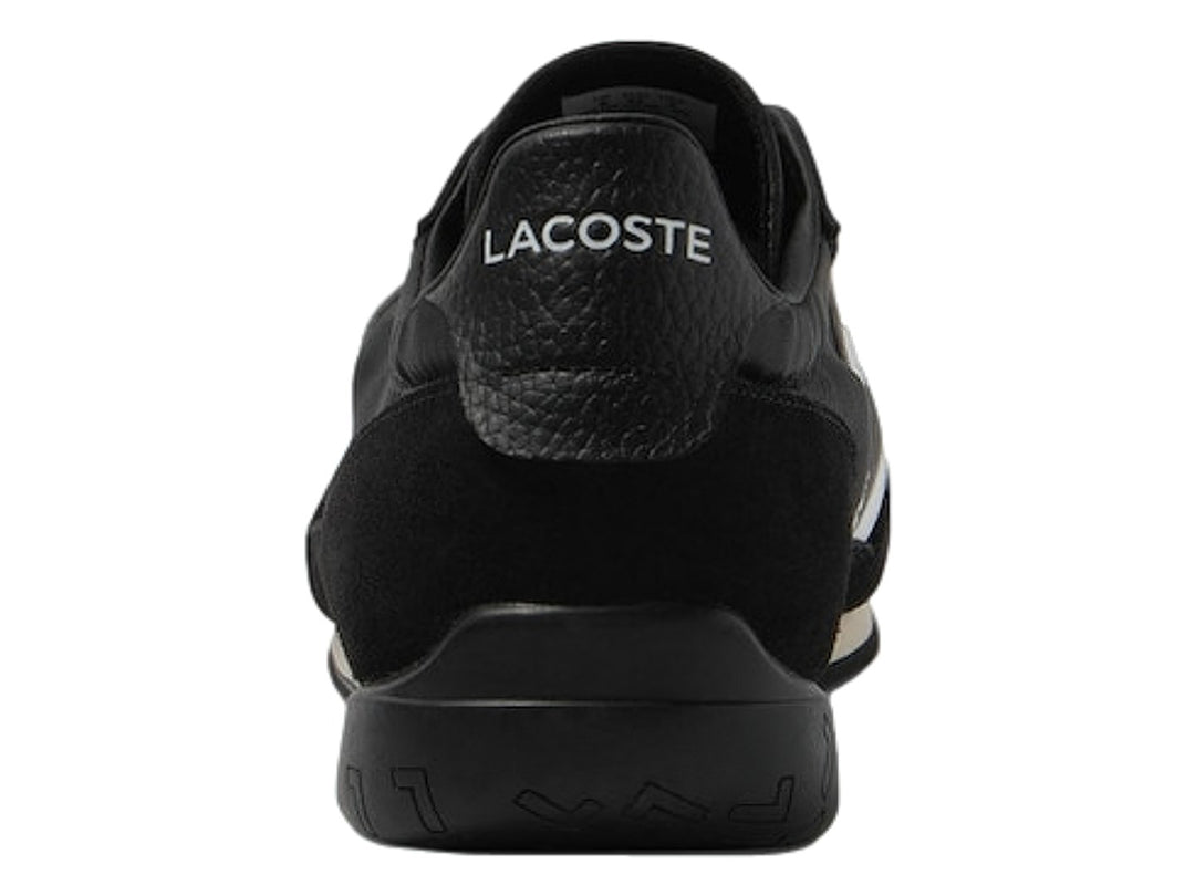 Tenis deportivos Lacoste de color negro con franjas laterales blancas y suela negra.