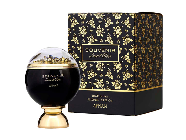 Perfume Afnan Souvenir Desert Rose en frasco negro y dorado con caja negra decorada con rosas doradas.