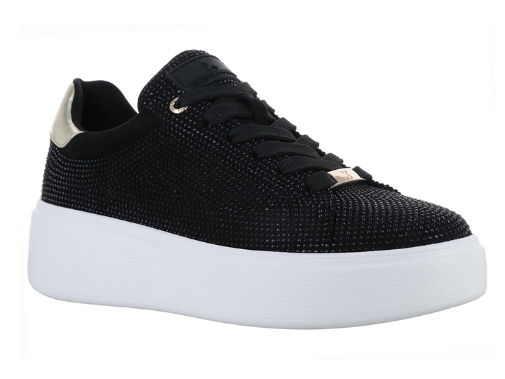 Tenis negros con detalles brillantes, suela blanca de plataforma y detalle dorado en el talón.