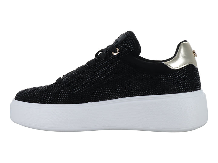 Tenis negros con detalles brillantes, suela blanca de plataforma y detalle dorado en el talón.