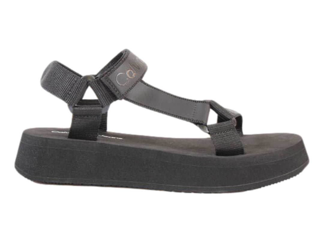 Sandalia de plataforma color negro con correas de velcro y suela gruesa.