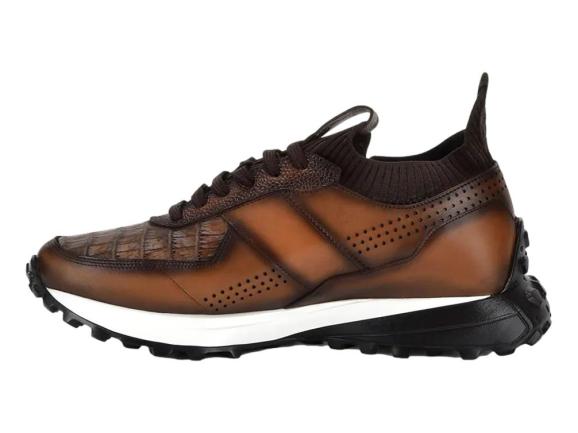Tenis de cuero color marrón almendra con suela blanca y negra y detalles perforados.