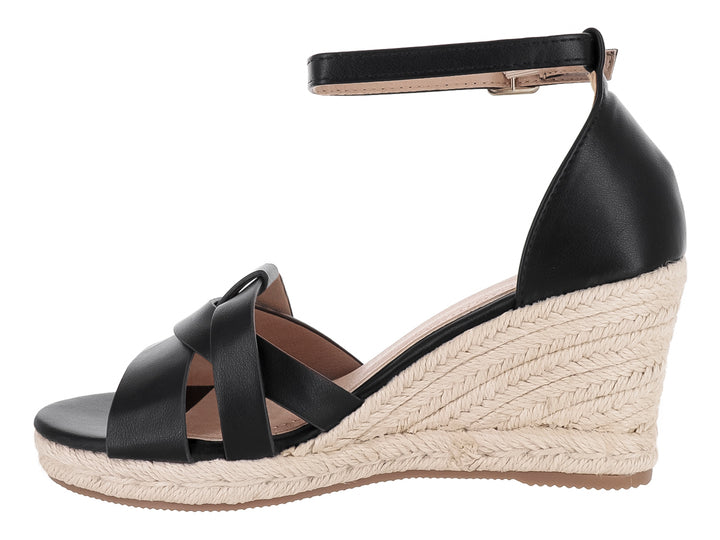 Sandalia de cuña color negro con suela de yute tejido y correa ajustable al tobillo.