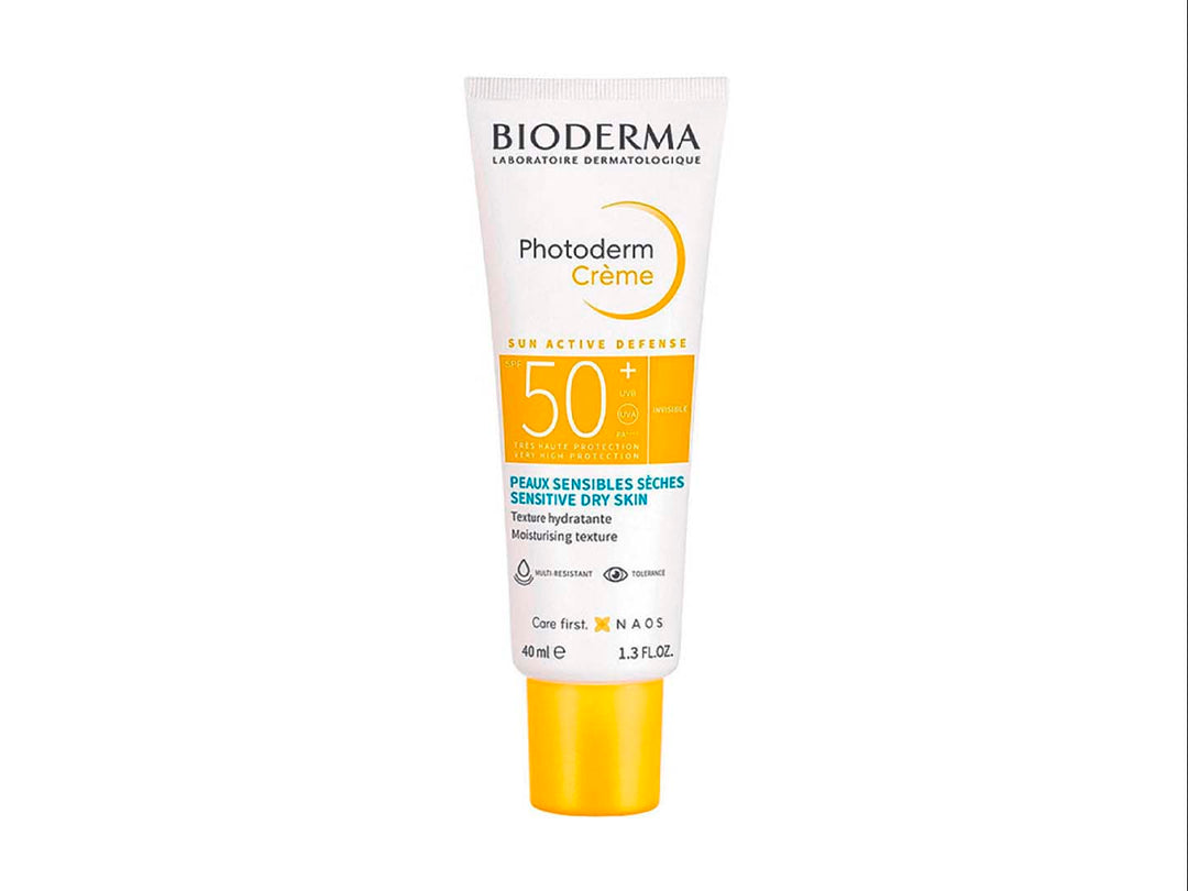 Tubo de crema protectora solar Bioderma Photoderm Crème SPF 50+ de 40 ml con tapa amarilla sobre fondo blanco.