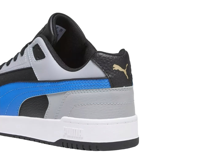 Tenis PUMA RBD Game Low en colores gris, negro y azul con suela blanca.