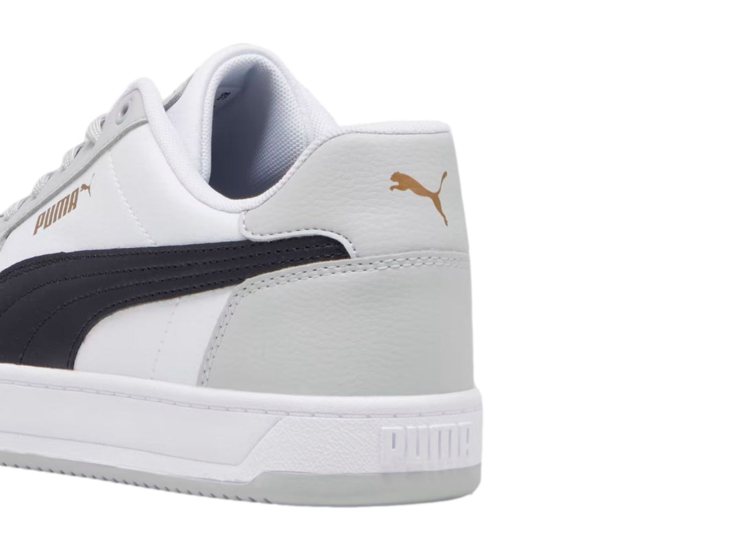 Tenis PUMA Caven 2.0 en color blanco con detalles en gris y negro, diseño deportivo de corte bajo.