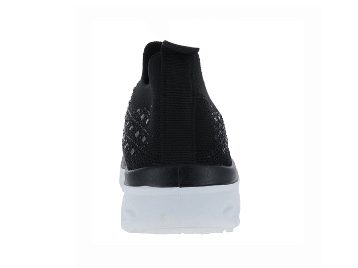 Tenis deportivos ATOK color negro con suela blanca gruesa y diseño sin cordones en tejido transpirable.