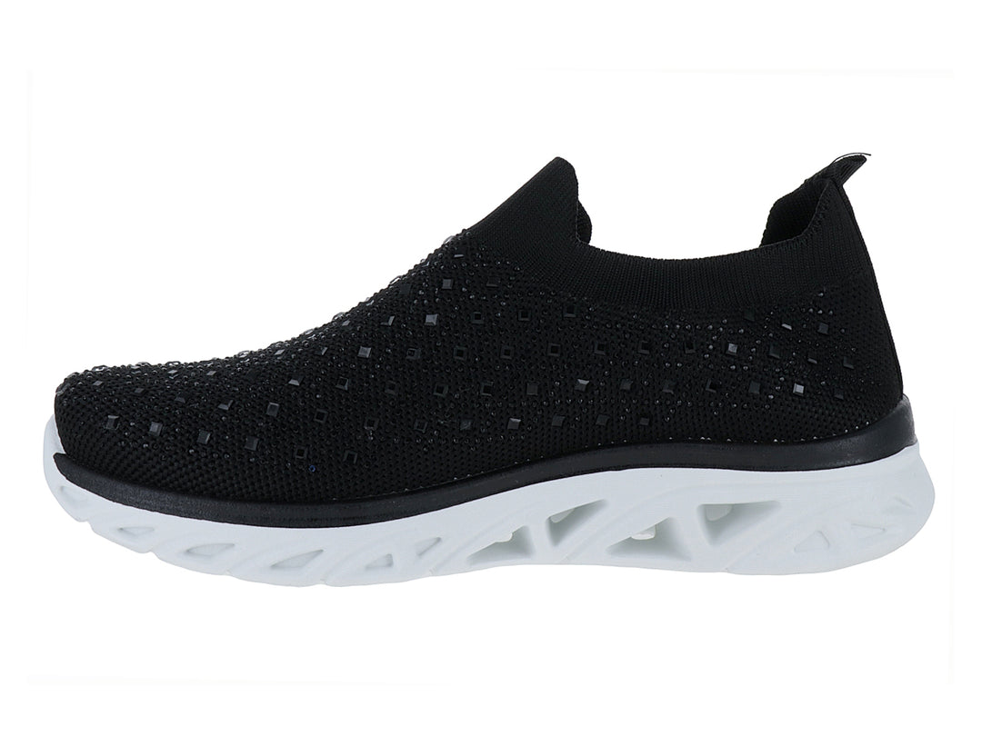 Tenis deportivos ATOK color negro con suela blanca gruesa y diseño sin cordones en tejido transpirable.