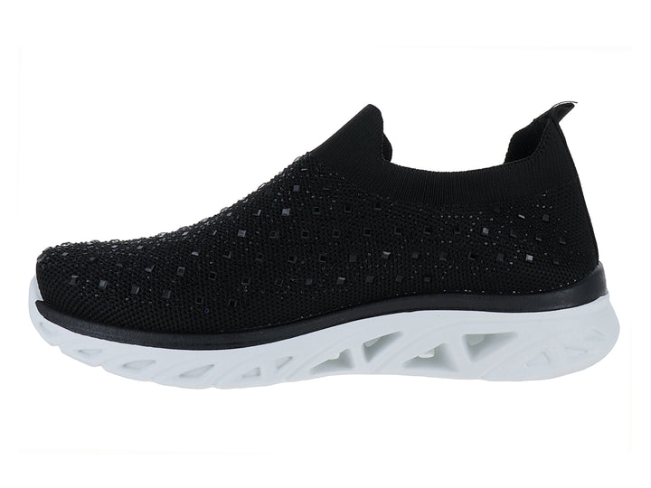 Tenis deportivos ATOK color negro con suela blanca gruesa y diseño sin cordones en tejido transpirable.