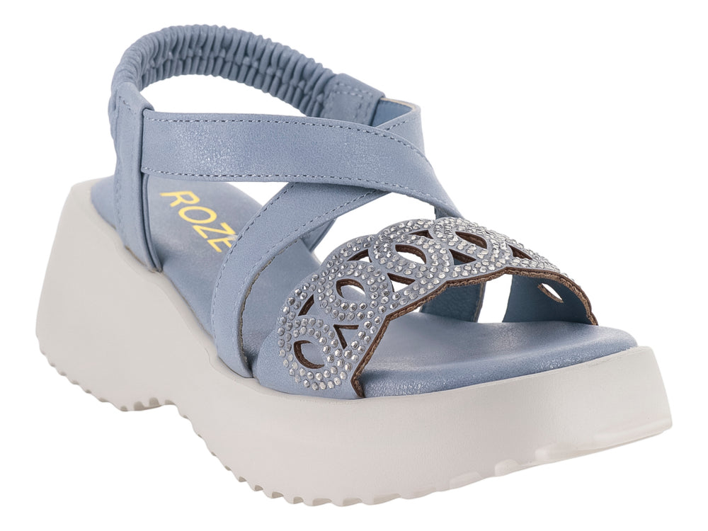Sandalia azul para niña con suela de plataforma blanca y adorno frontal.
